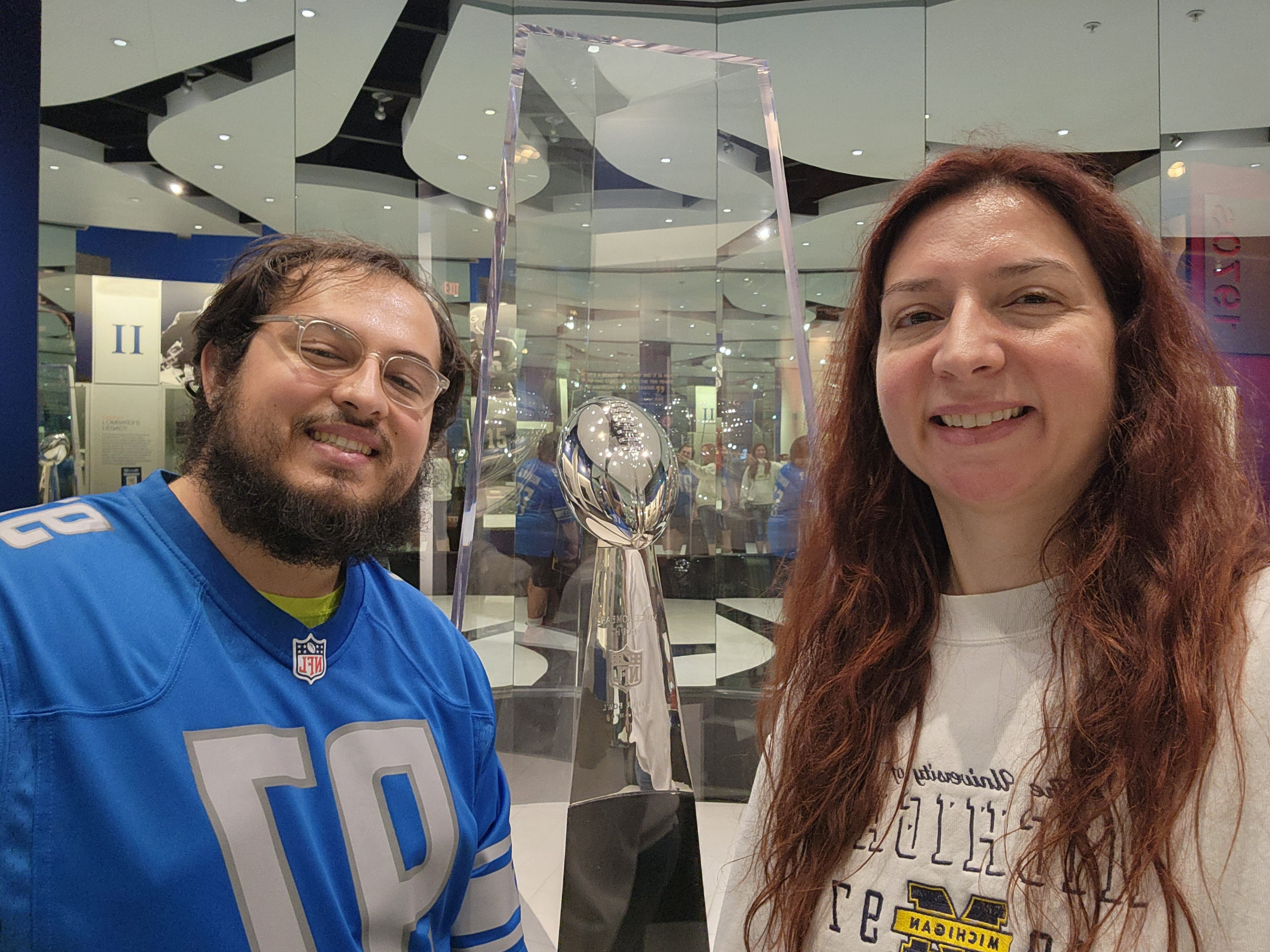Alex and Jessica at the Pro Football Hall of Fame next to the Lombardi Trophy